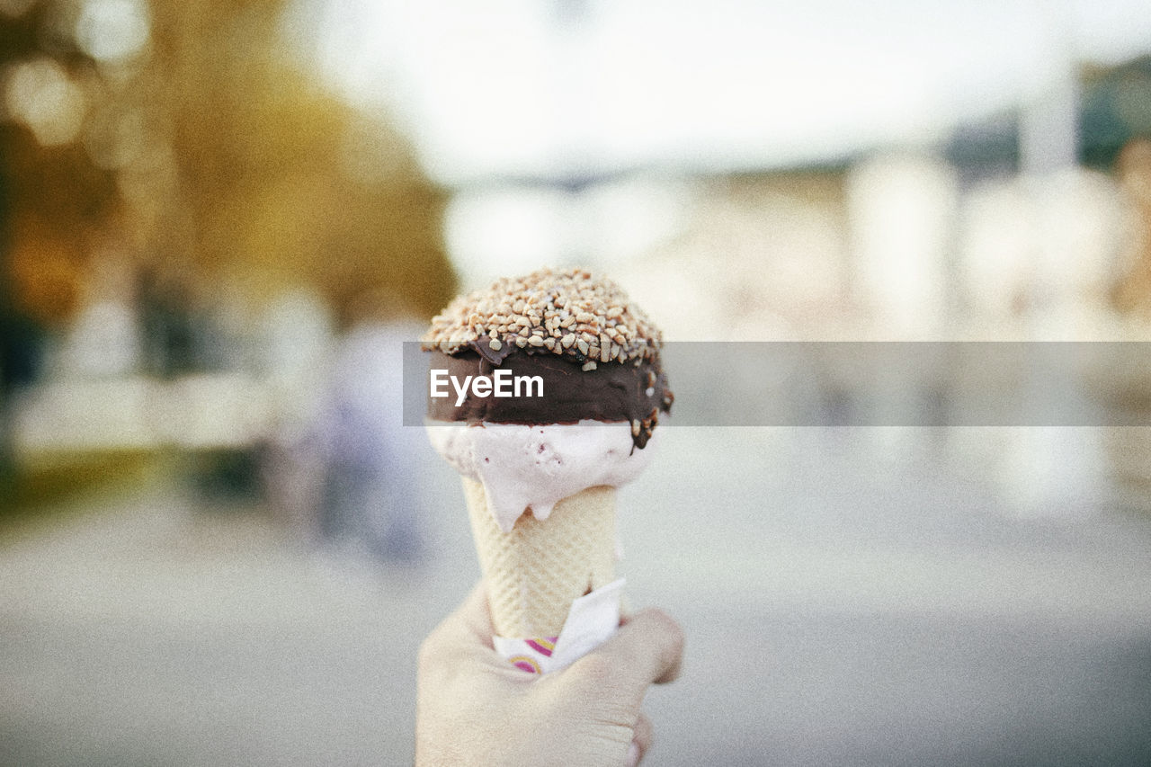 Close-up of hand holding ice cream cone