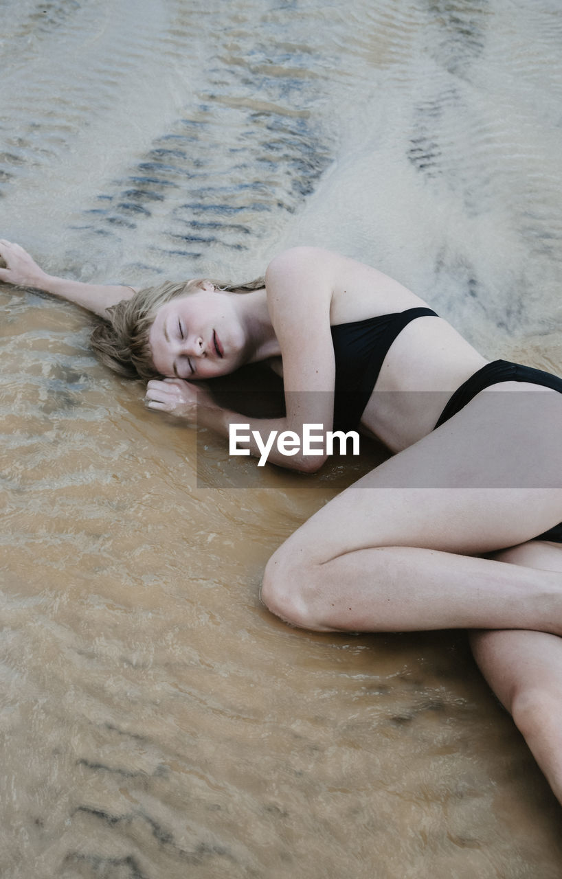 High angle view of woman sitting on beach