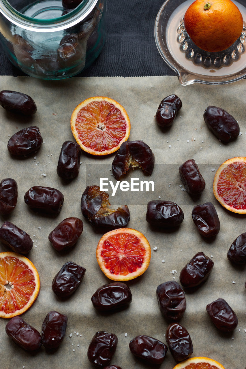 High angle view of blood oranges and dates on table