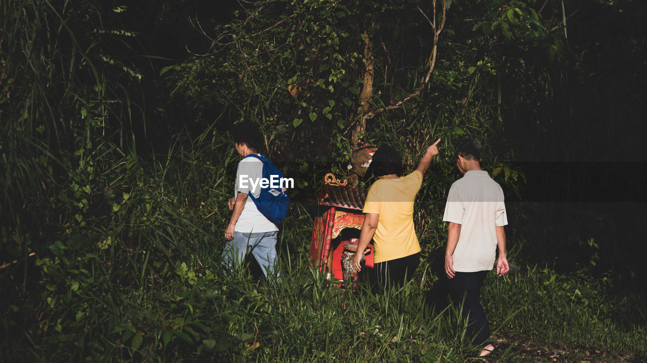 Friends walking in forest at night