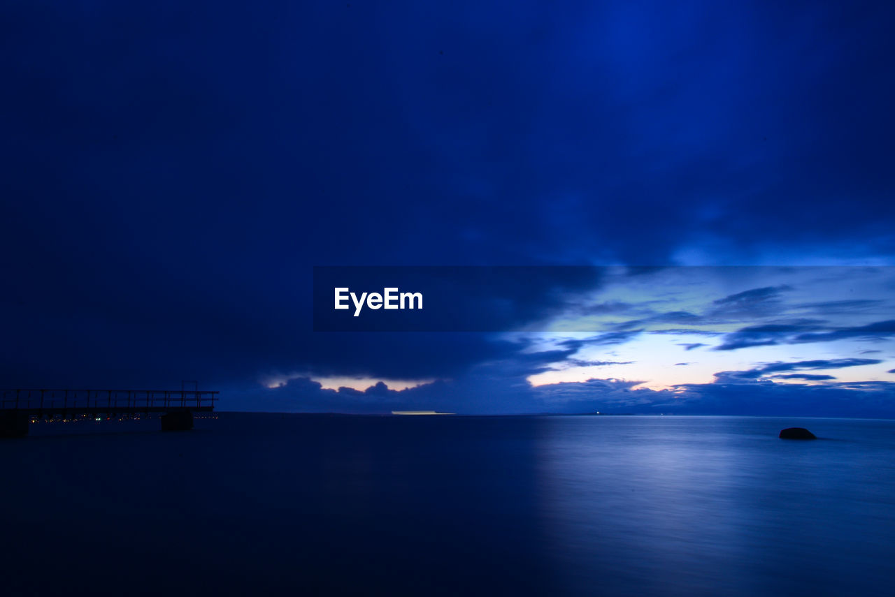 Scenic view of sea against sky at sunset