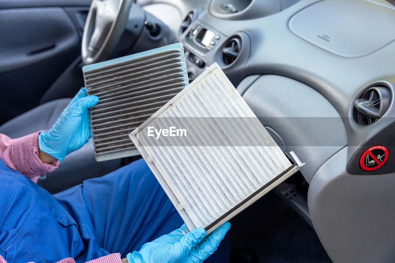 Replacement of cabin pollen air filter for a car. basic auto mechanic skills concept.