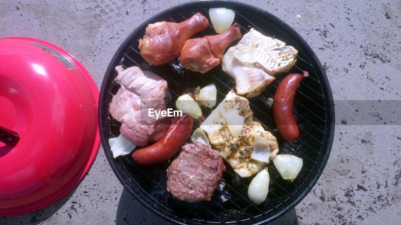 Directly above shot of meat cooking on barbecue grill