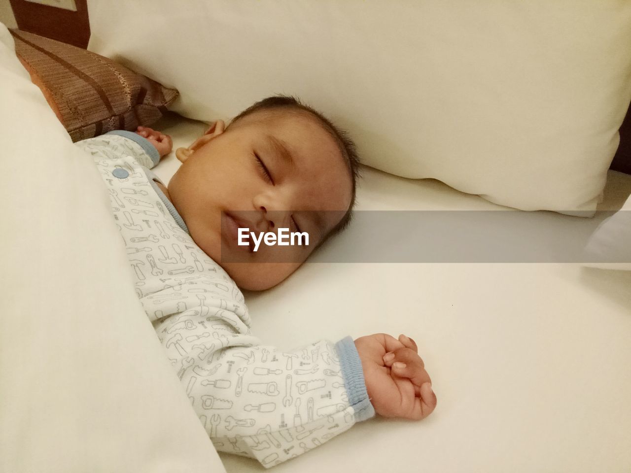 Cute baby sleeping on bed at home