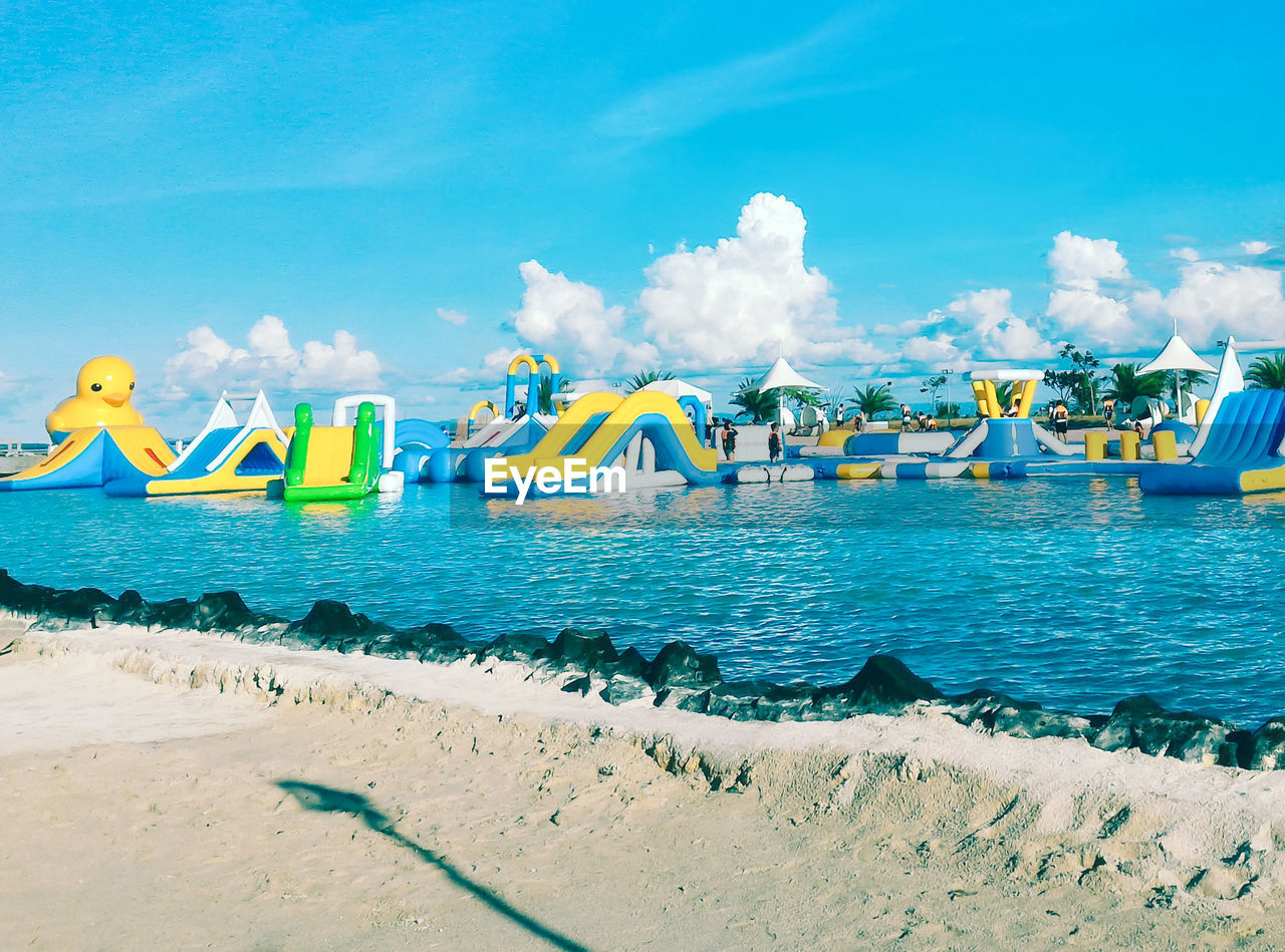 PANORAMIC SHOT OF BEACH AGAINST BLUE SKY