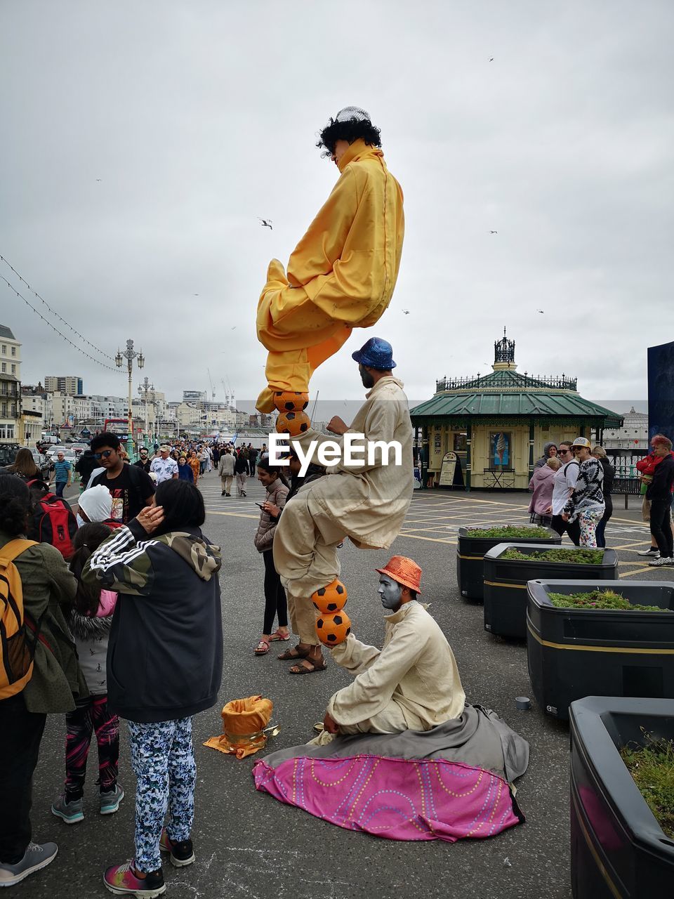 GROUP OF PEOPLE IN FRONT OF CITY