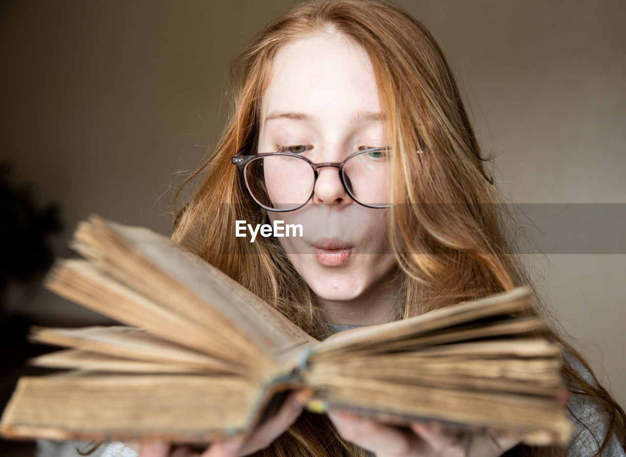 portrait of young woman looking away against black background