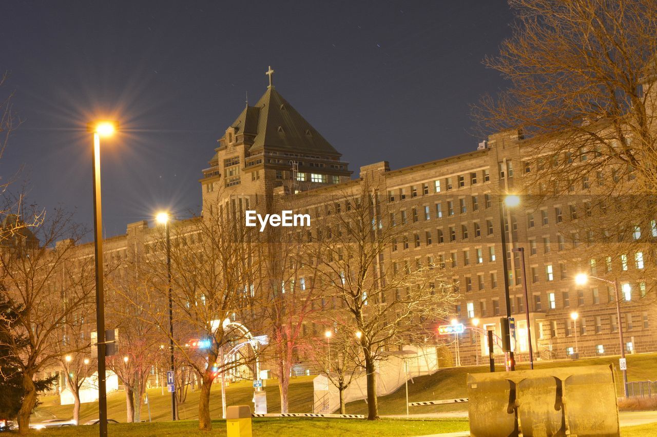 VIEW OF ILLUMINATED CITY AT NIGHT