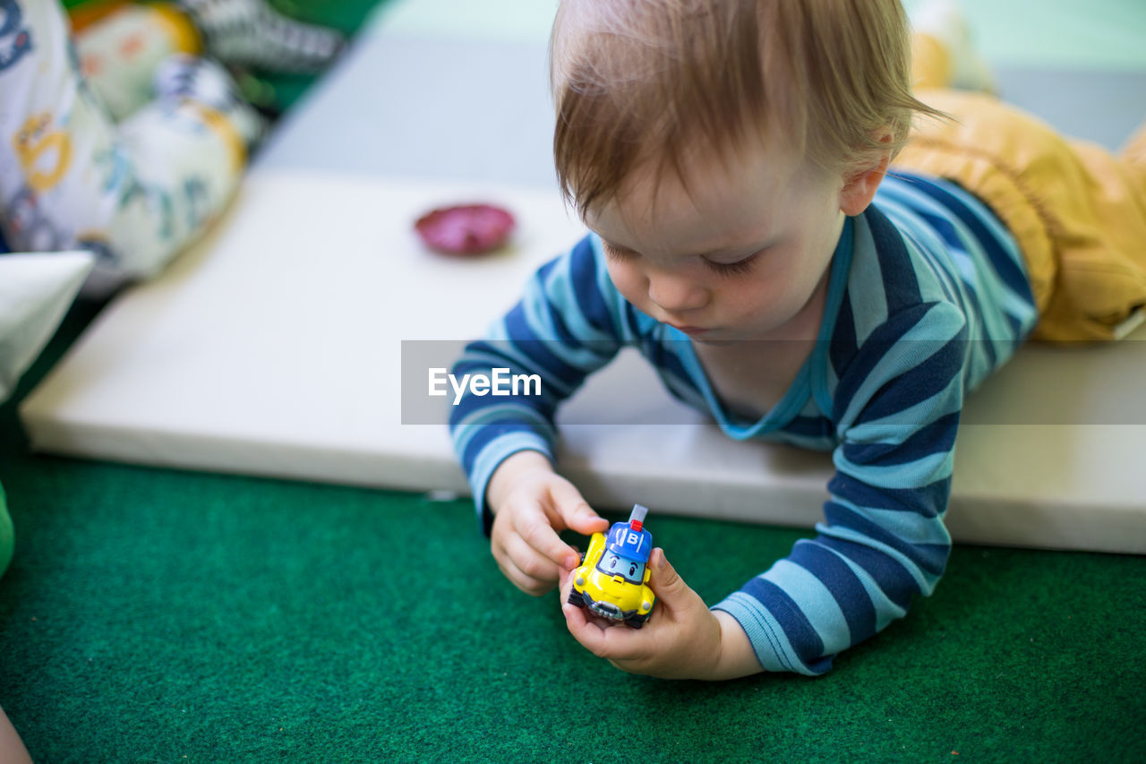 close-up of boy playing with toy blocks at home