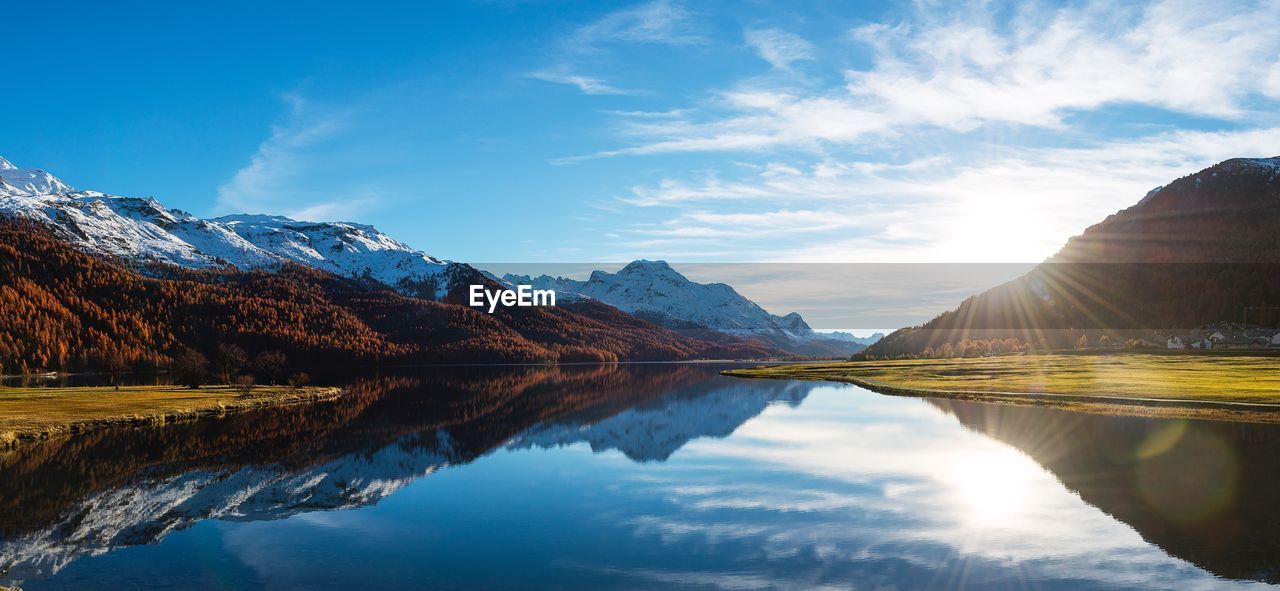 Scenic view of lake and mountains against sky