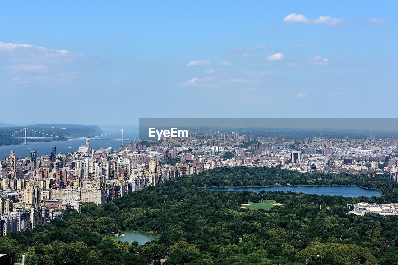 Aerial view of cityscape by sea against sky