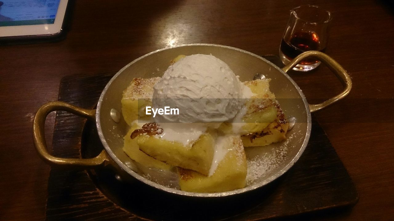 High angle view of french toasts with ice cream in cooking pan