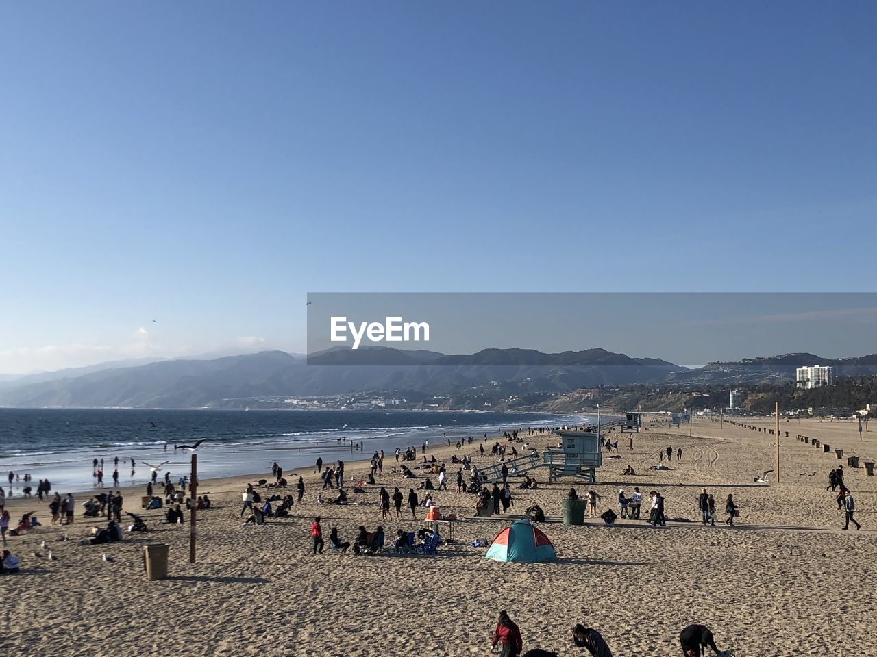 Group of people on beach against sky