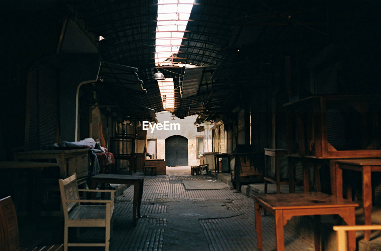 Empty chairs and table in old building