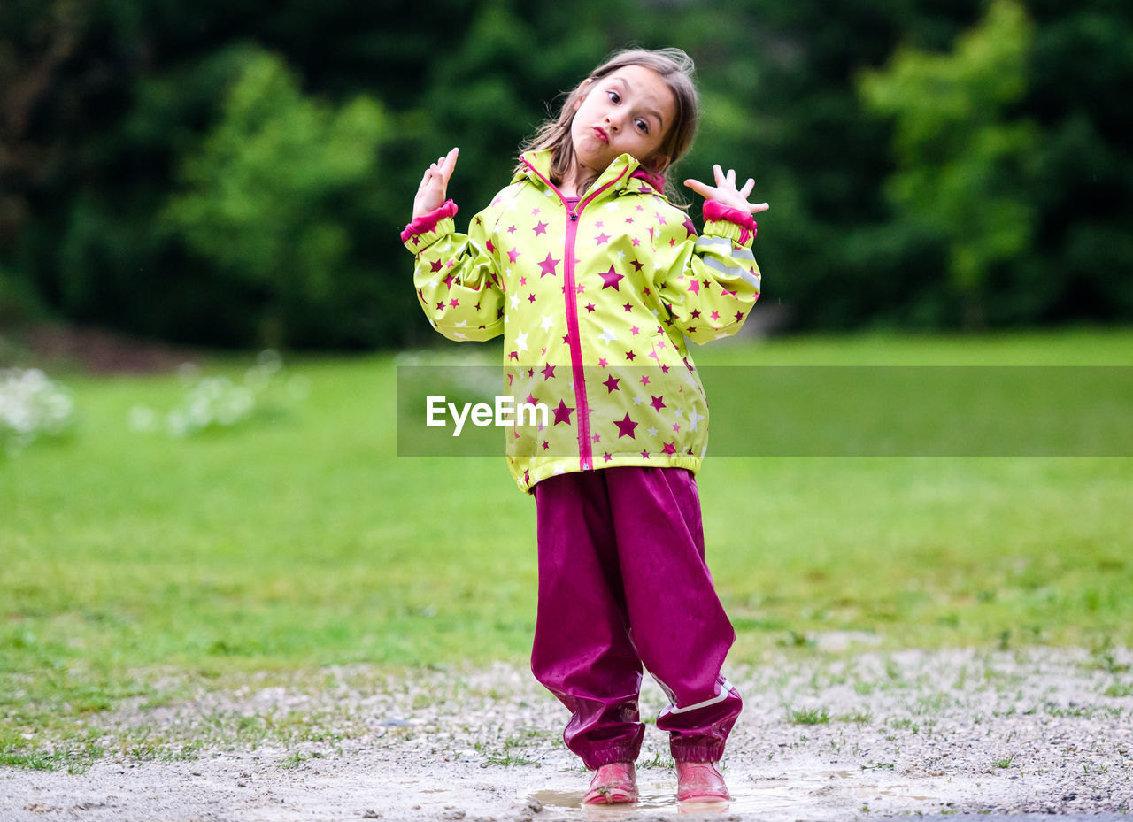 Portrait of girl standing in puddle