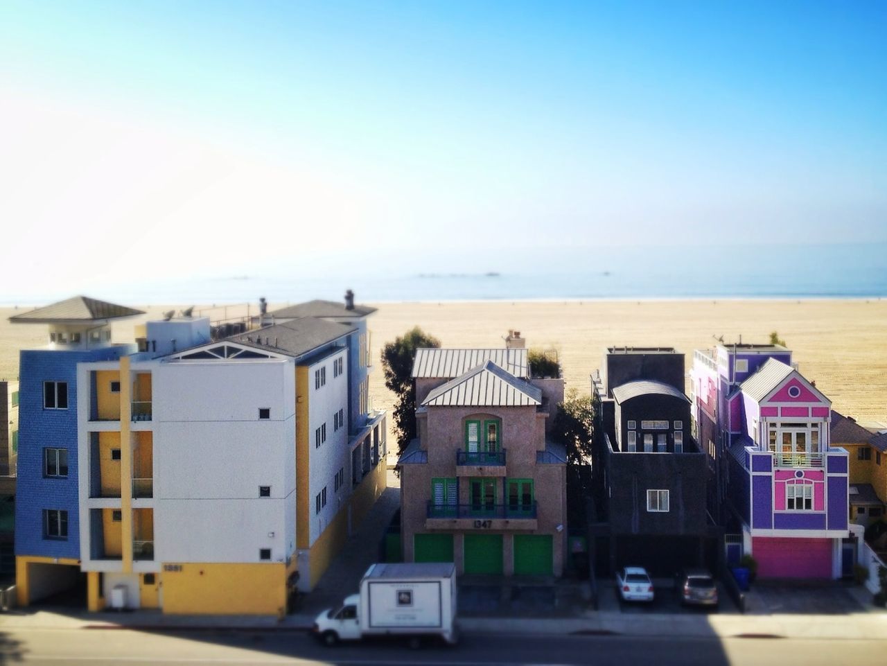 High angle view of residential structures with calm beach in background