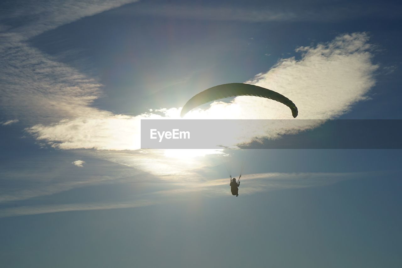 LOW ANGLE VIEW OF PERSON FLYING IN SKY