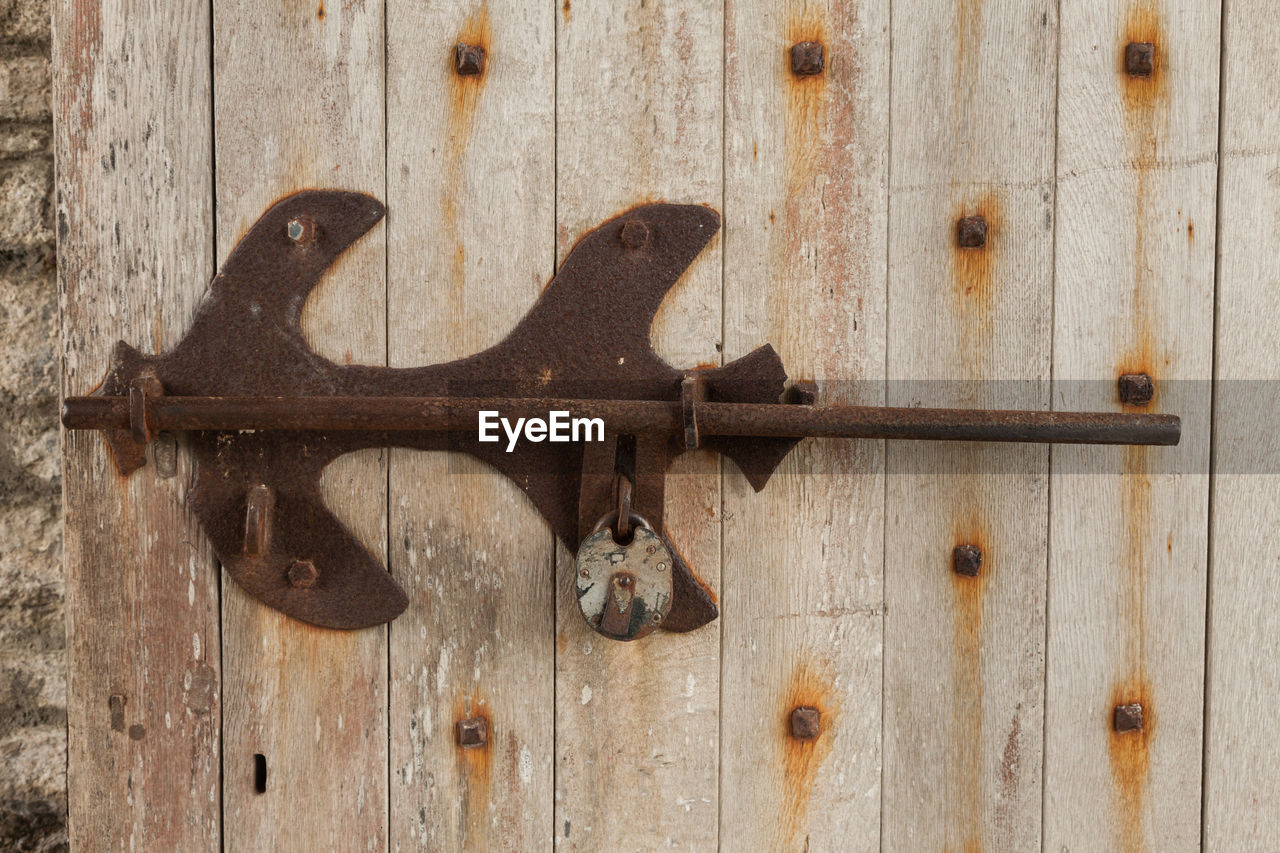 Rusty metal on wooden door
