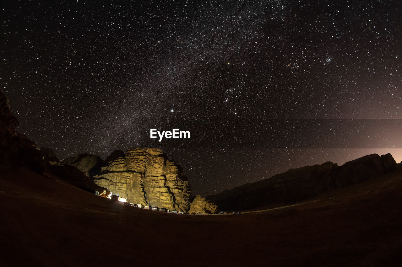 Scenic view of mountains against sky at night