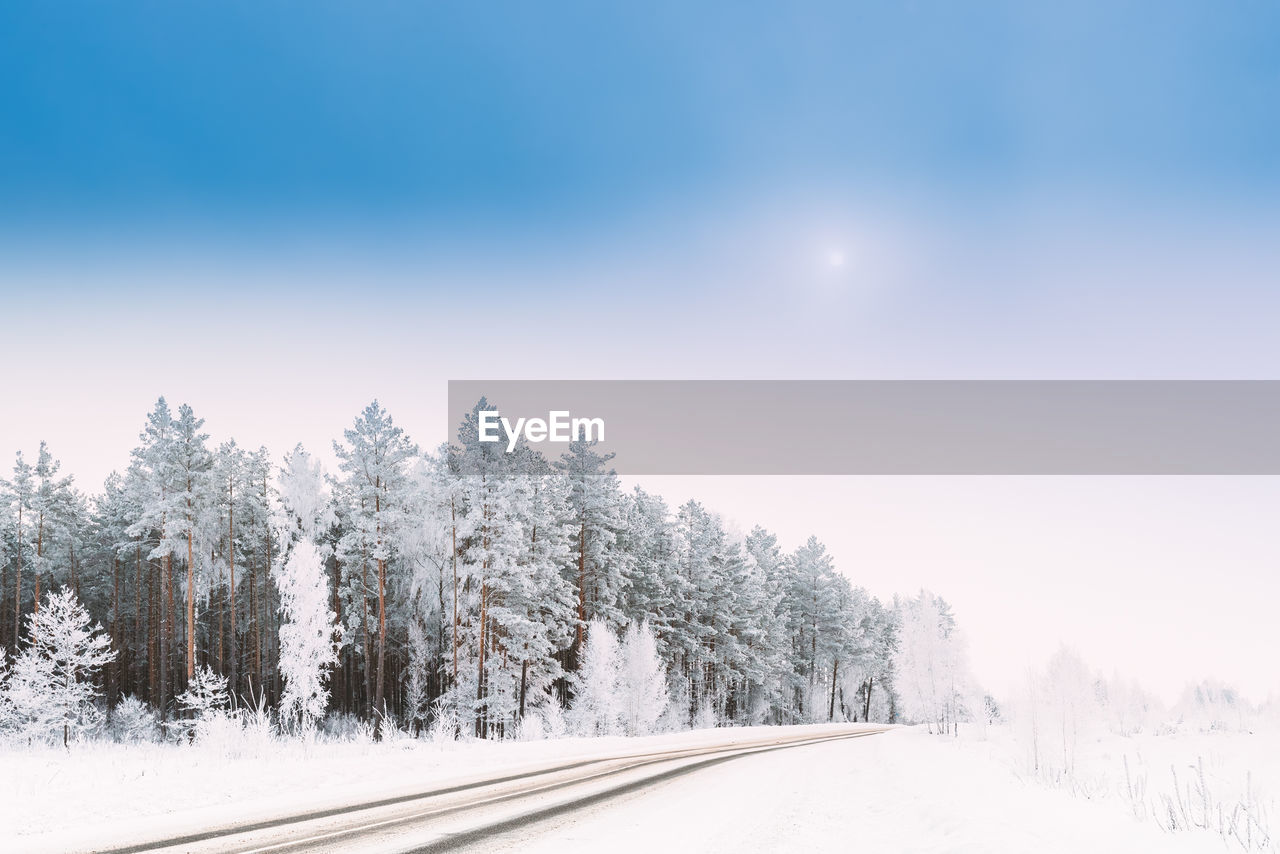 snow covered road against sky