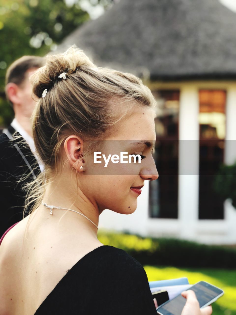 Close-up of thoughtful teenage girl standing outdoors