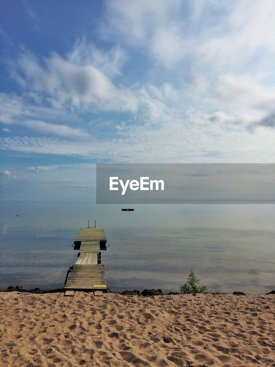 High angle view of jetty towards sea at beach against sky