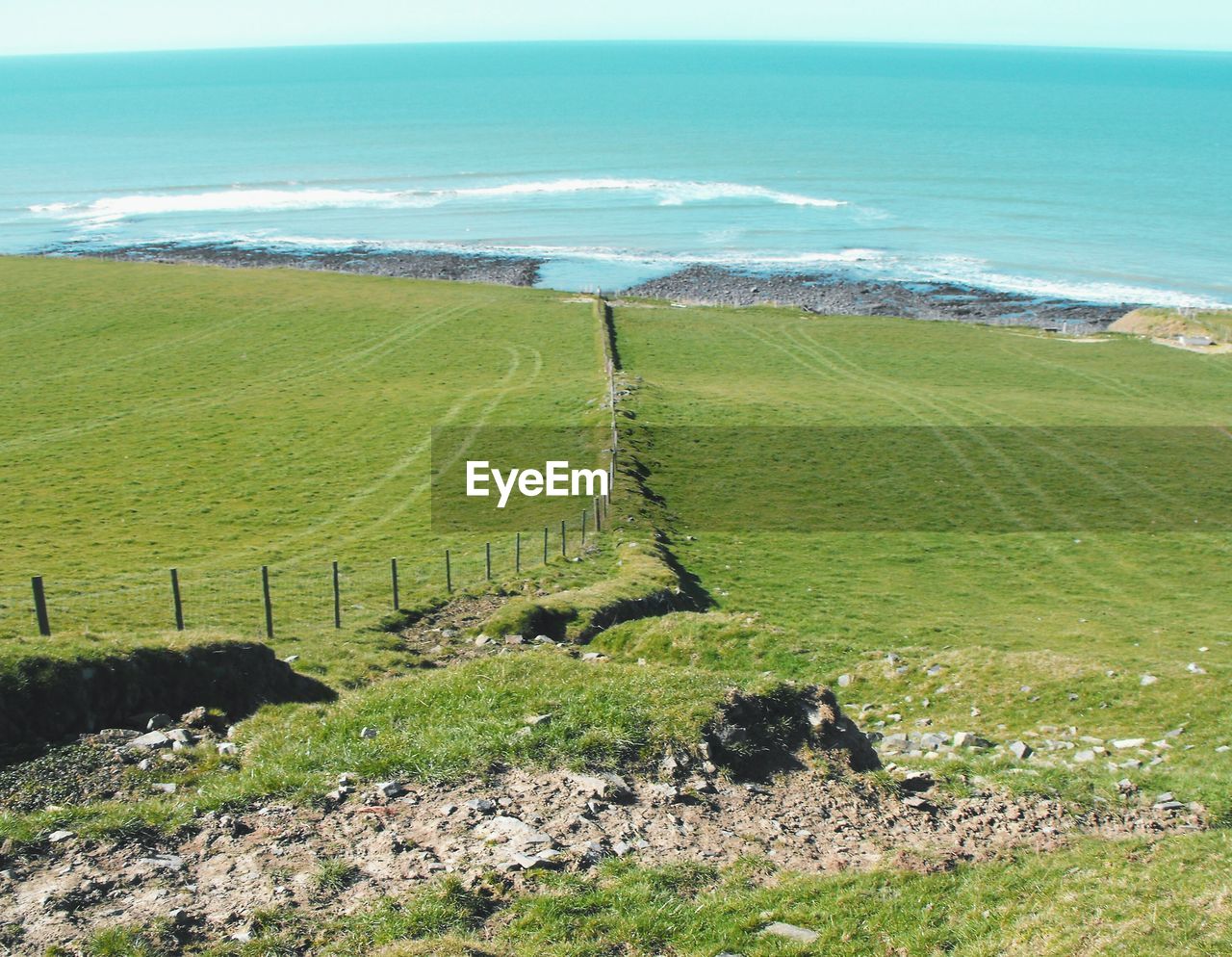 High angle view of field against sea