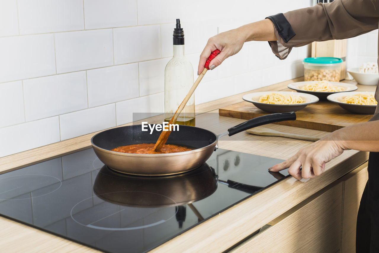 cropped hand of person preparing food in kitchen