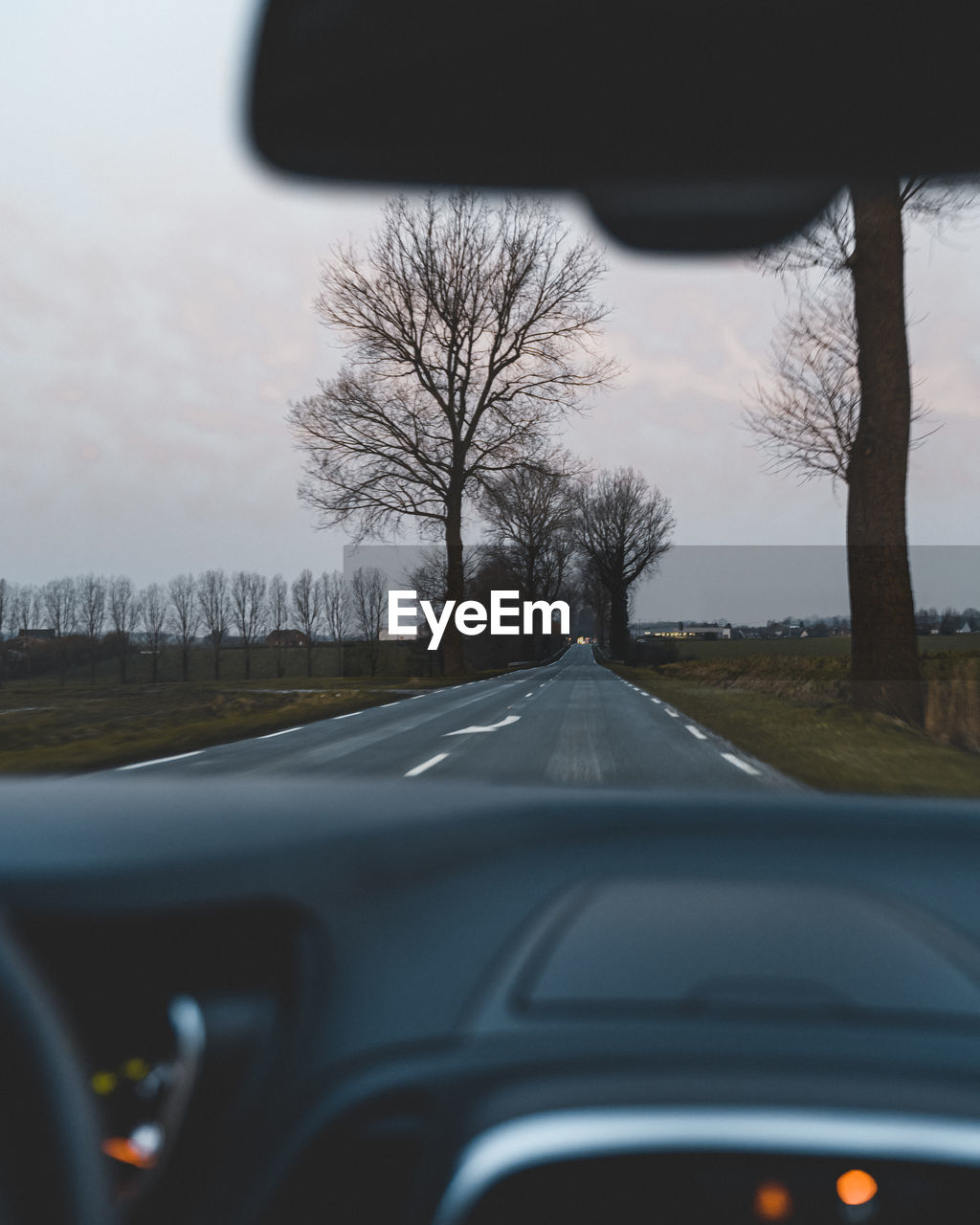 ROAD SEEN THROUGH WINDSHIELD OF CAR