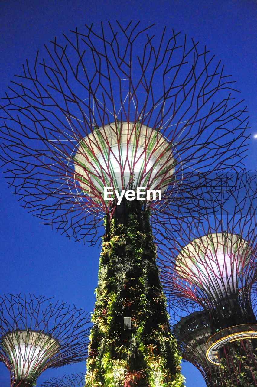 Low angle view of illuminated sculpture against sky