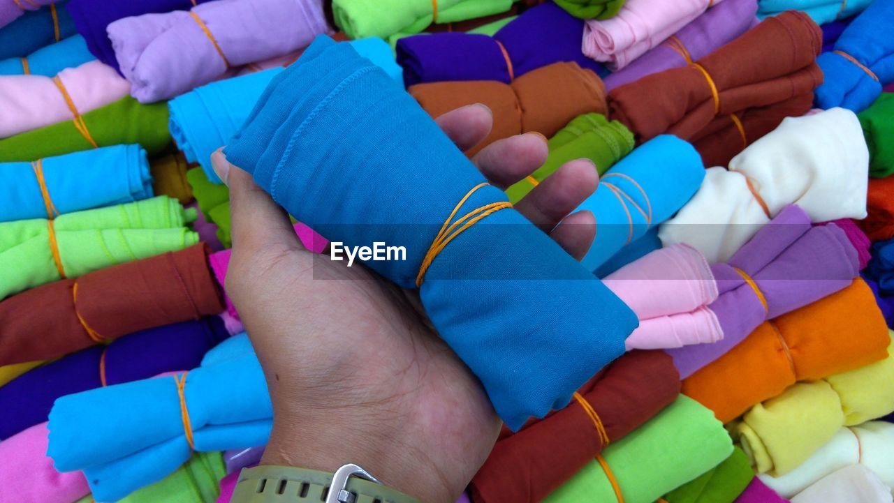 Cropped hand holding colorful fabric