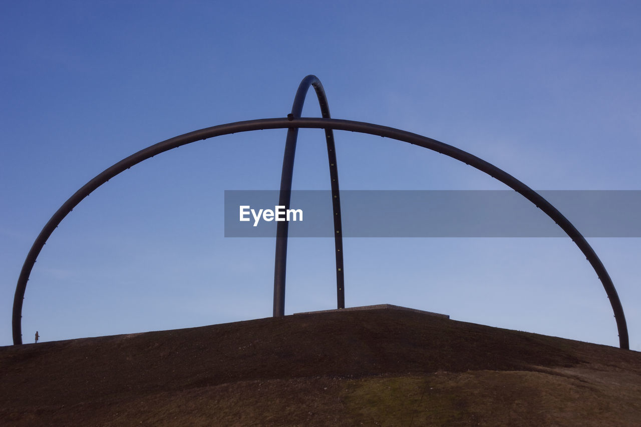 LOW ANGLE VIEW OF METALLIC STRUCTURE AGAINST SKY