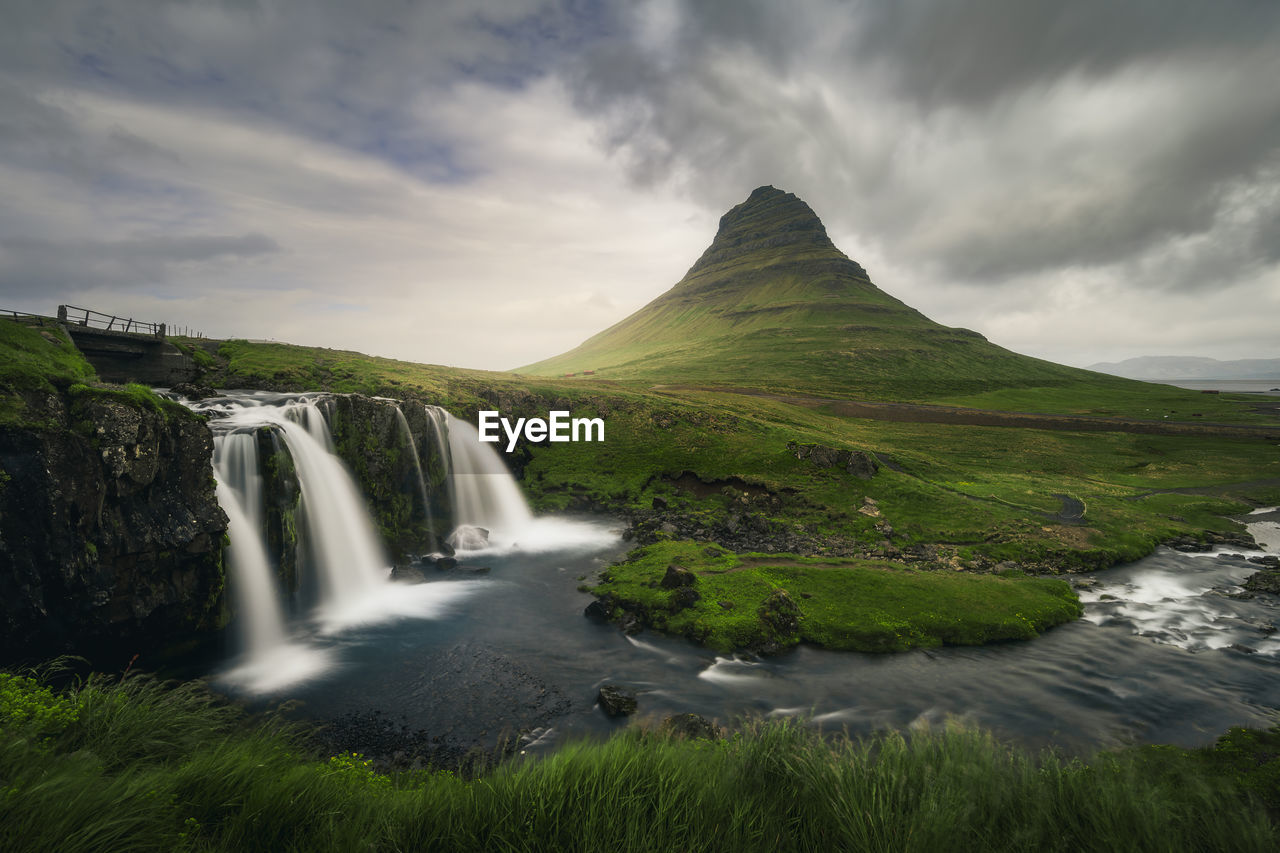 Scenic view of kirkjufell mountain and kirkjufellfoss waterfall, iceland, snæfellsnes peninsula