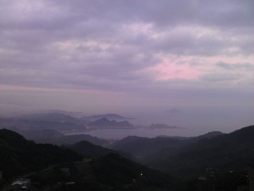 SCENIC VIEW OF MOUNTAINS AGAINST CLOUDY SKY AT SUNSET