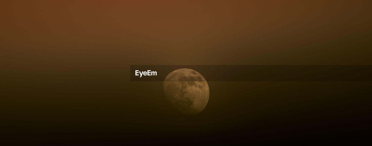 LOW ANGLE VIEW OF HALF MOON AGAINST SKY AT NIGHT