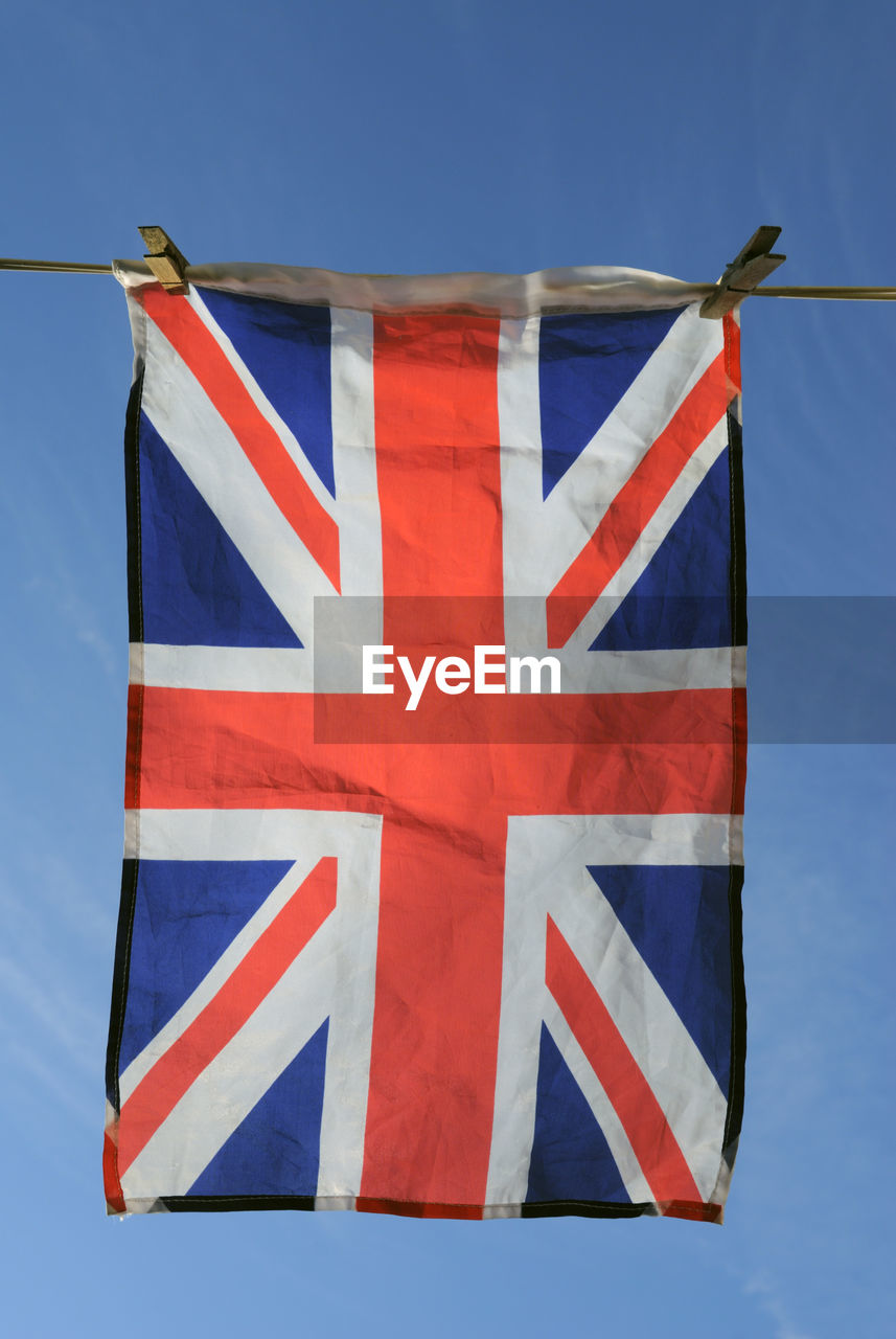 Low angle view of british flag hanging against sky