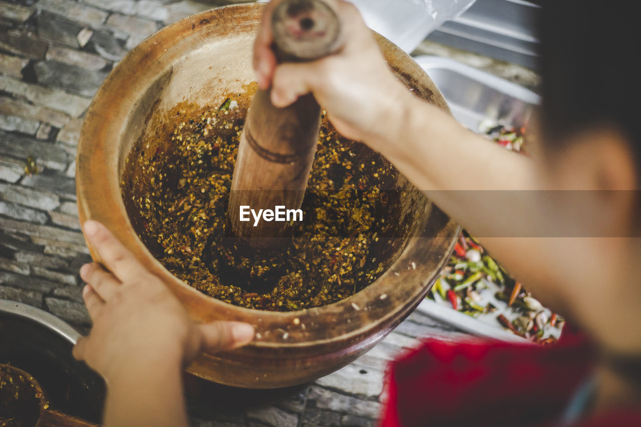 Midsection of man preparing food in kitchen