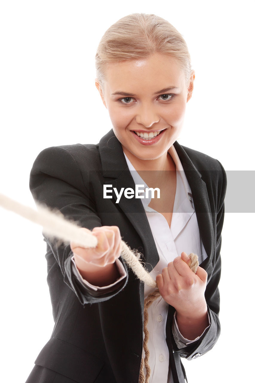 Businesswoman holding heart shape against white background
