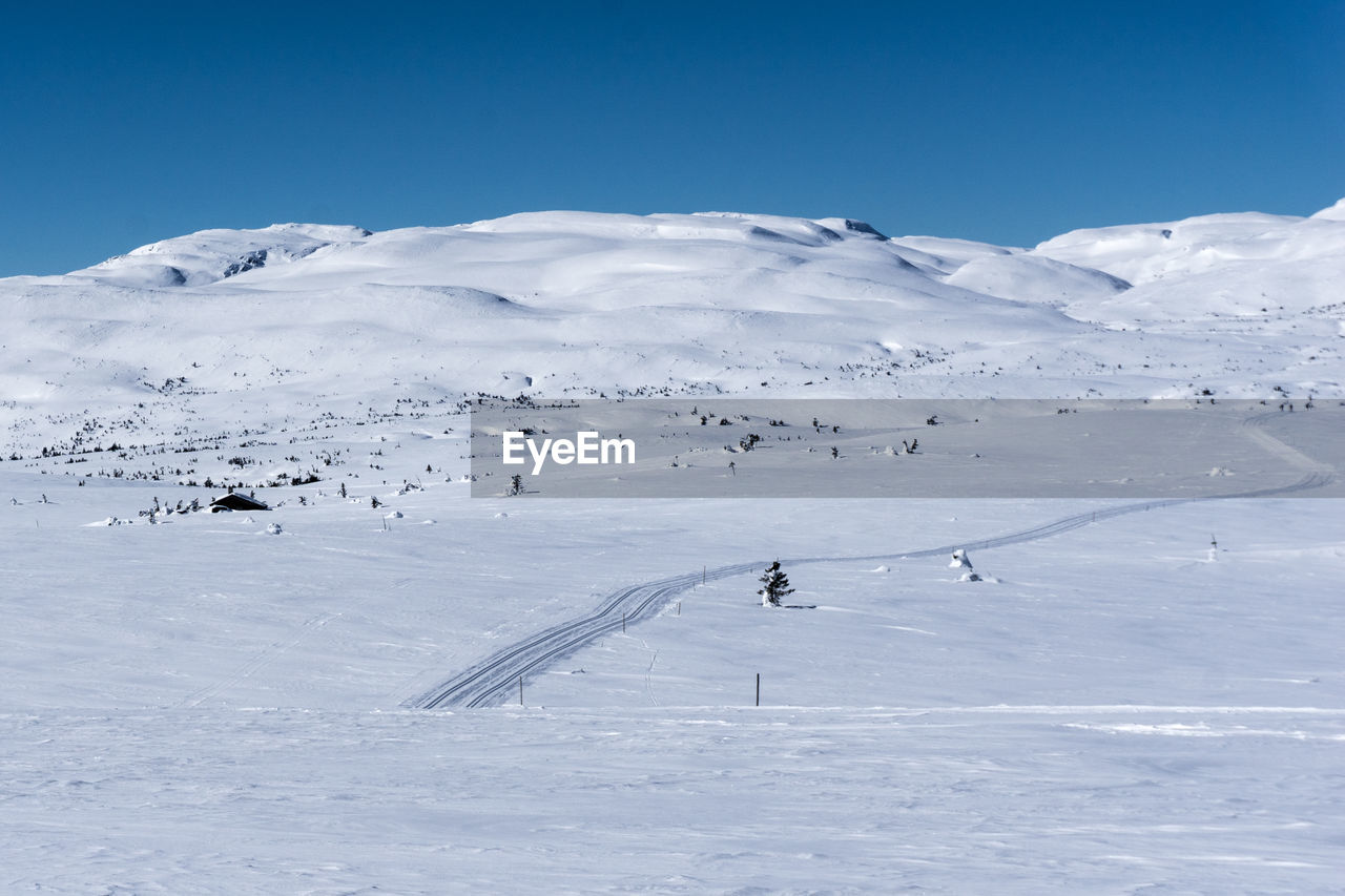 Scenic view of snow covered mountains against sky