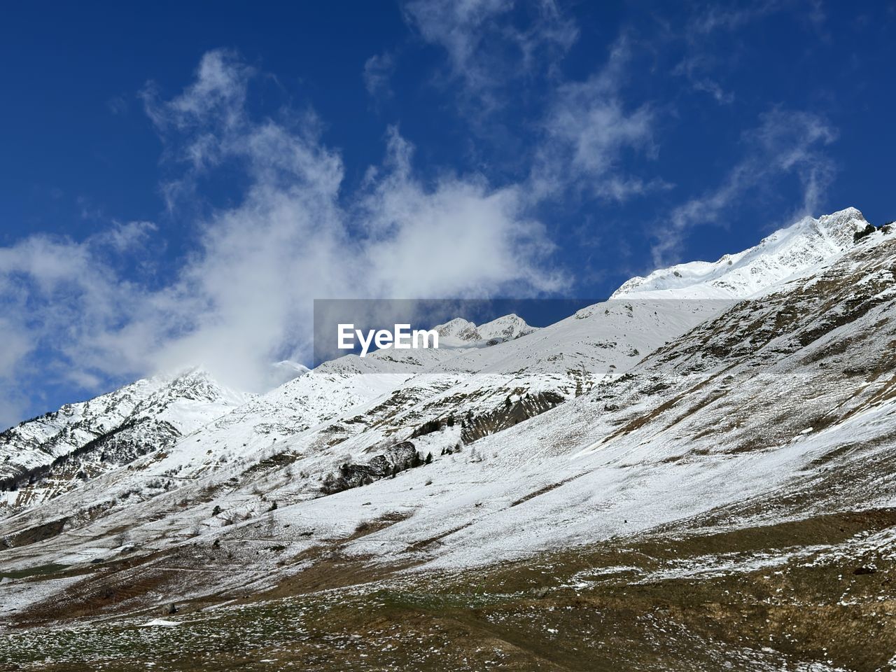 snow, mountain, cold temperature, winter, scenics - nature, environment, landscape, sky, mountain range, beauty in nature, snowcapped mountain, cloud, nature, plateau, ridge, travel, travel destinations, no people, non-urban scene, tranquil scene, tranquility, white, extreme terrain, day, summit, tourism, outdoors, mountain pass, blue, mountain peak, land, glacier, awe, ice, idyllic, physical geography, frozen