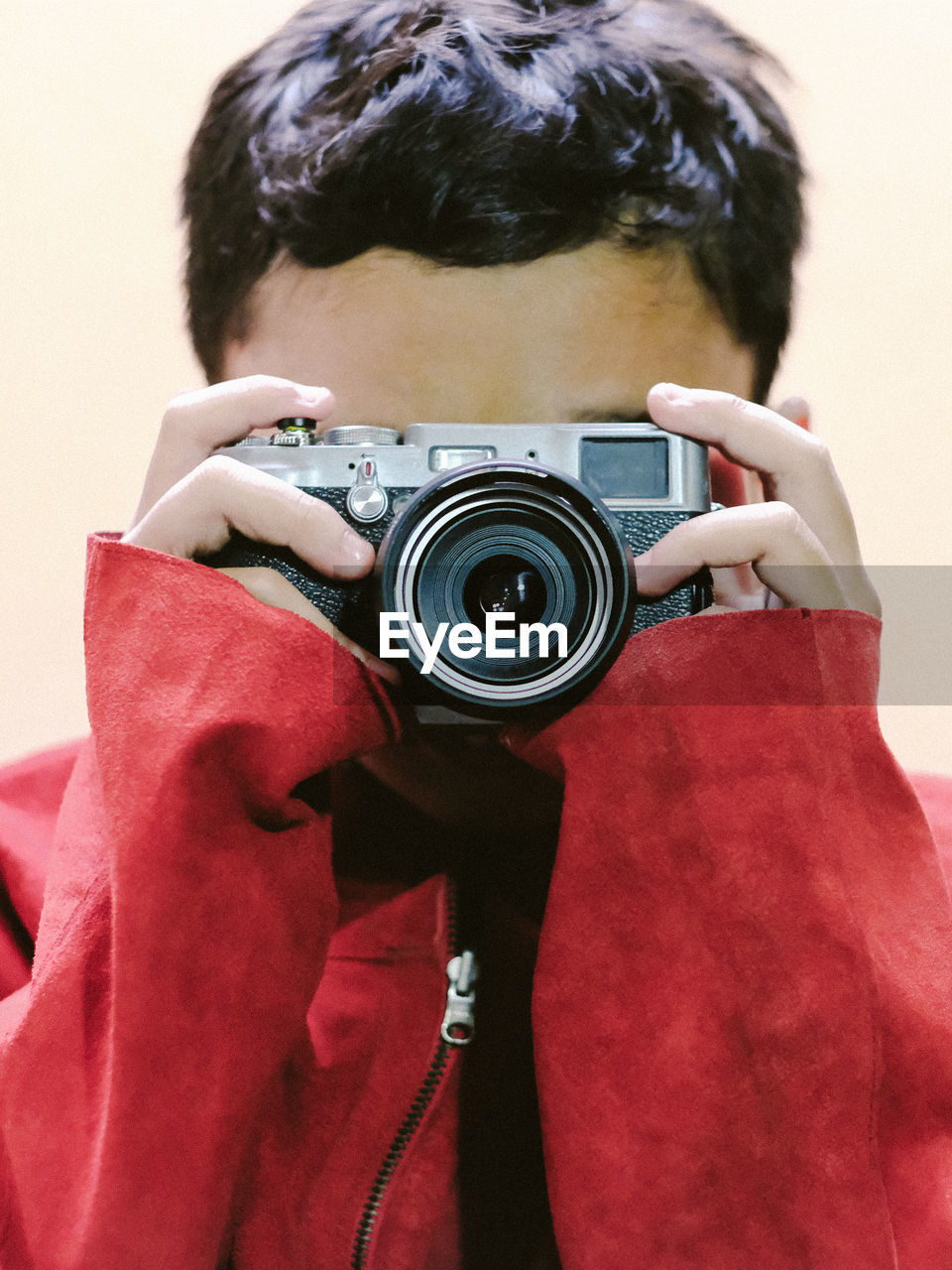 Portrait of a boy holding a digital camera