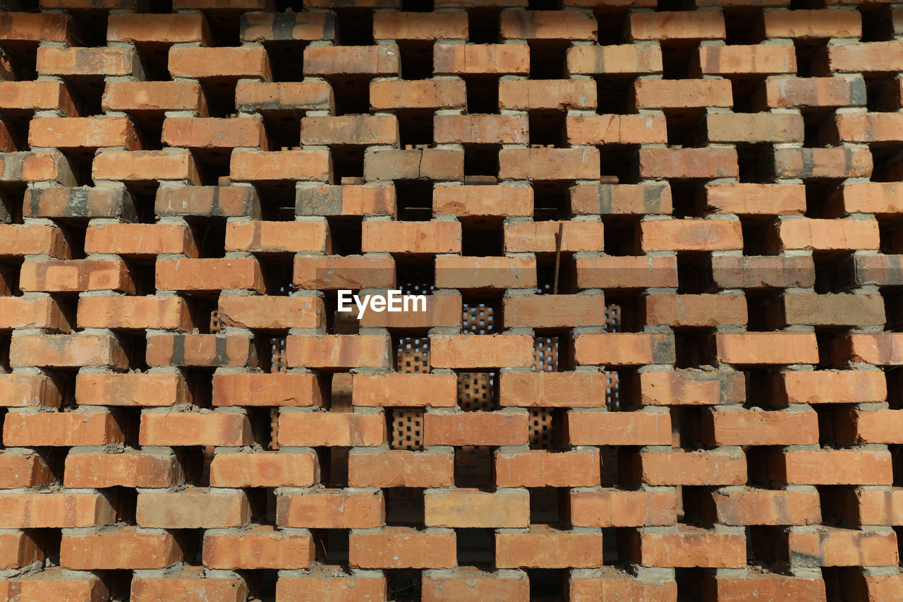 pattern, backgrounds, full frame, floor, flooring, brick, art, no people, brown, repetition, circle, brickwork, wall, textured, tile, shape, large group of objects, abundance, indoors, line, road surface