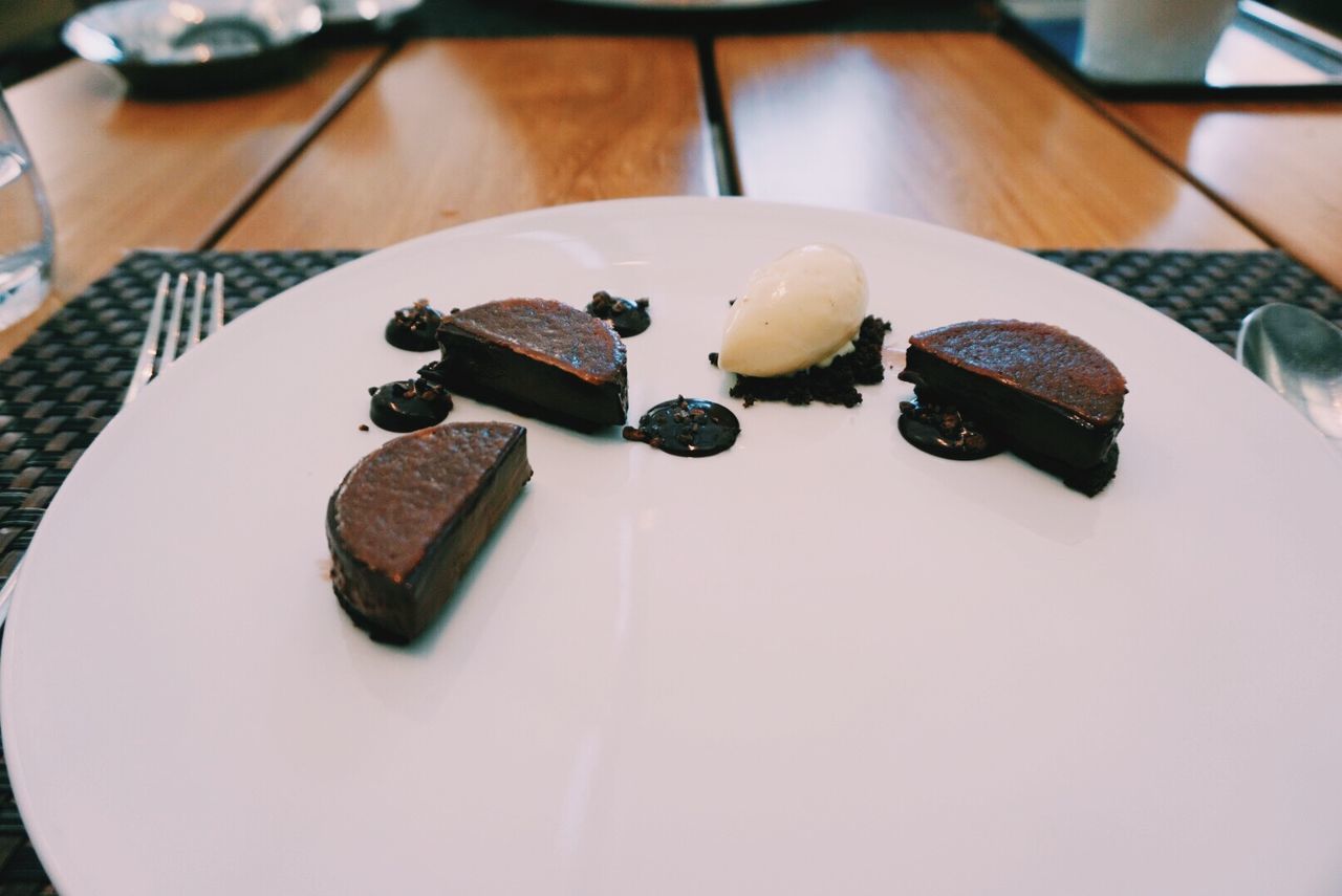 Chocolate and salted caramel cake served on table