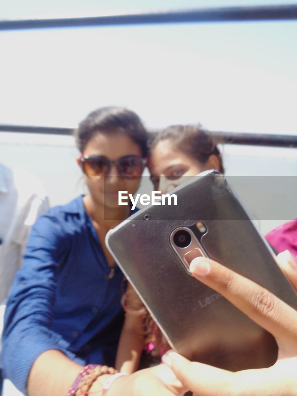 CLOSE-UP OF BOY PHOTOGRAPHING WHILE USING MOBILE PHONE IN MIRROR