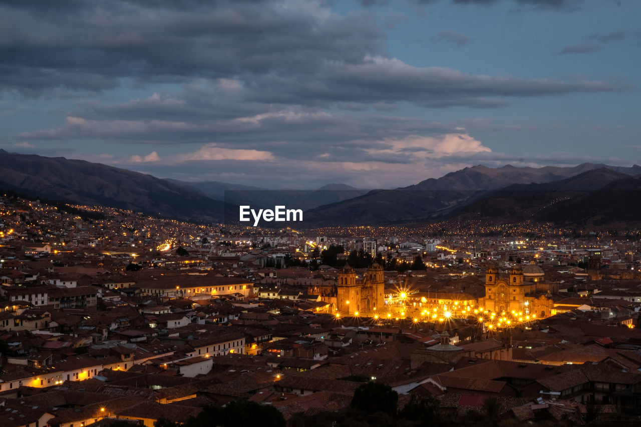 High angle shot of illuminated cityscape against sky