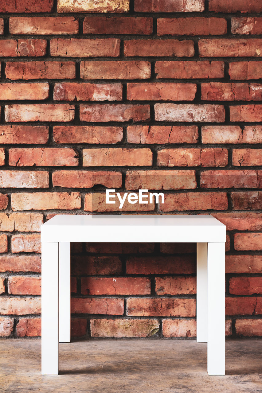 CLOSE-UP OF BRICK WALL AGAINST STONE WALLS