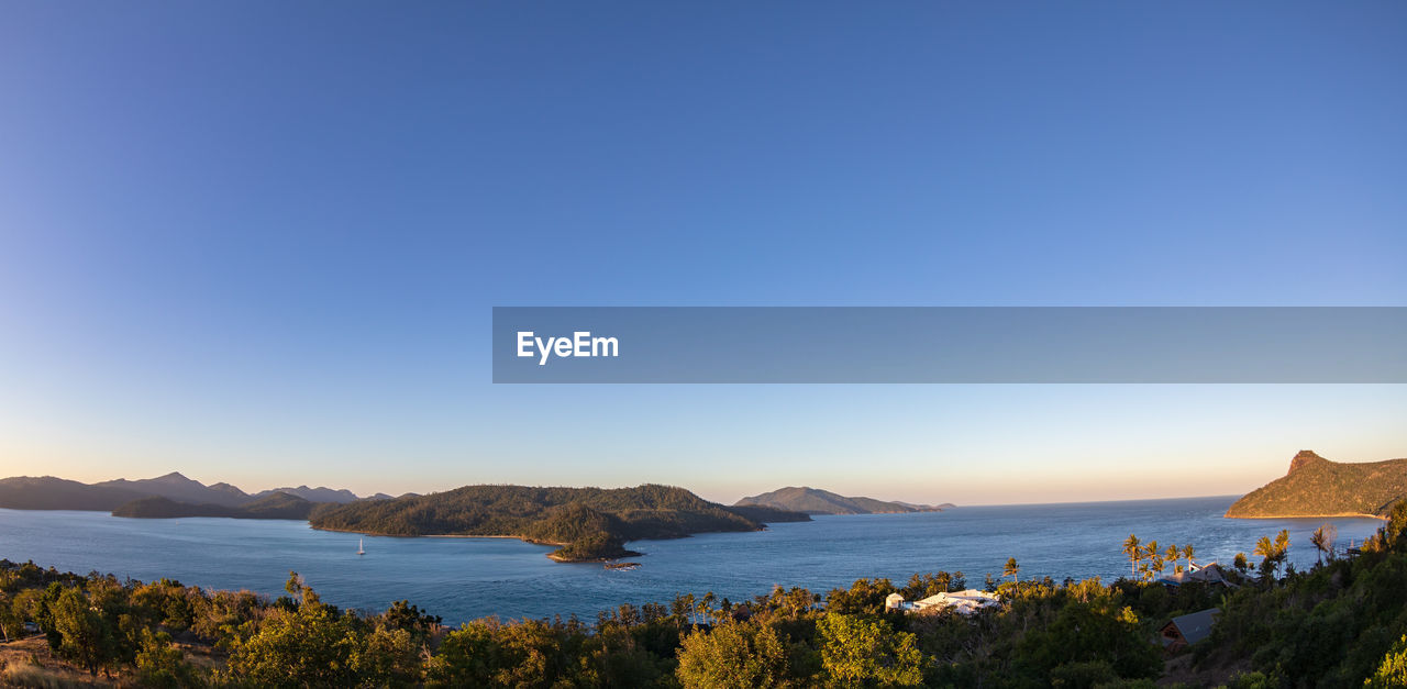 Scenic view of sea against clear blue sky