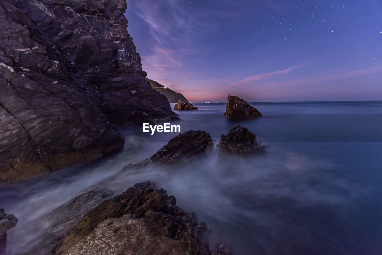 Scenic view of sea against sky at night