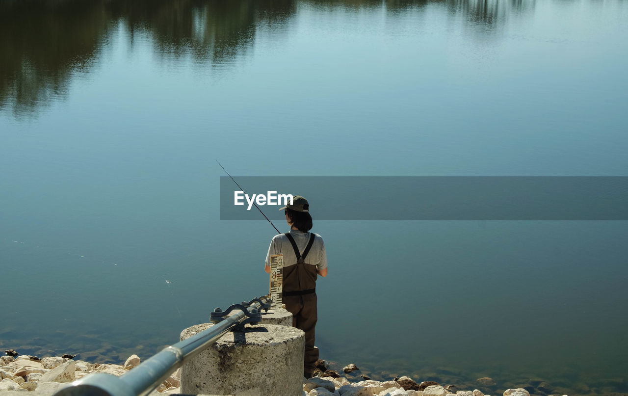 Rear view of woman fishing