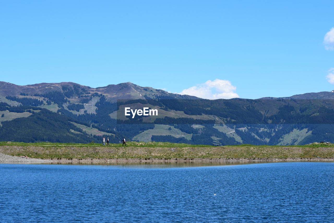 Scenic view of mountains against blue sky